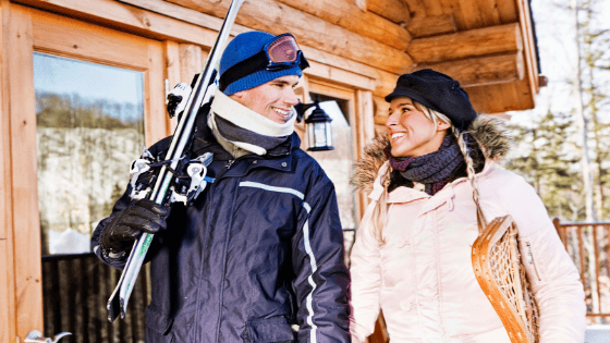Man and Woman with skis and snowshoes